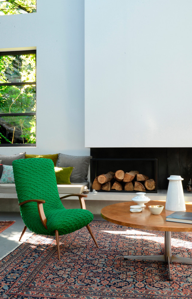 Le fauteuil vert Slimgreen de la designer brésilienne Regina Misk voisine avec une table basse vintage. Tapis...