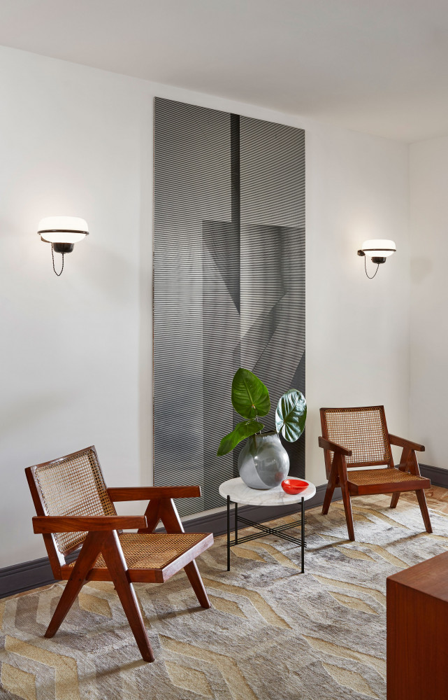 Entre deux fauteuils « Easy » de Pierre Jeanneret (galerie Downtown Paris), table d’appoint de GamFratesi (Gubi)...