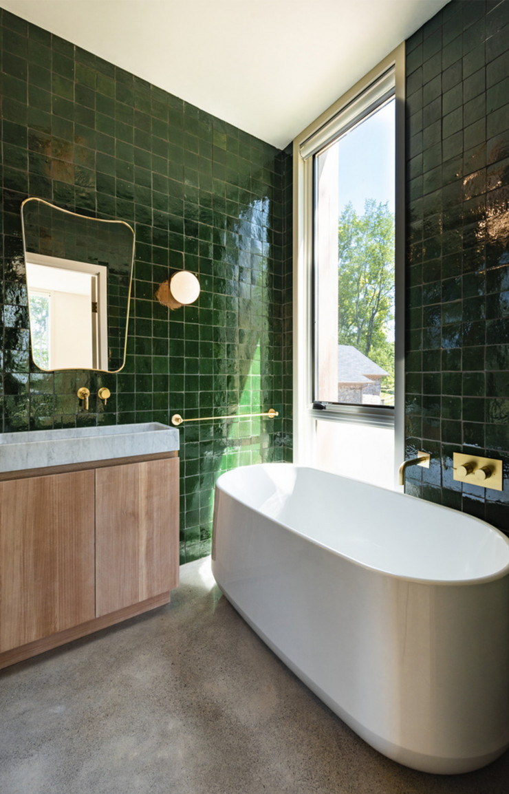 Dans la salle de bain, des carreaux verts entretiennent la confusion entre intérieur et extérieur.